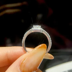 Silberner quadratischer Moissanit Ring mit Mikro-Pave-Halo und funkelnden Steinen.