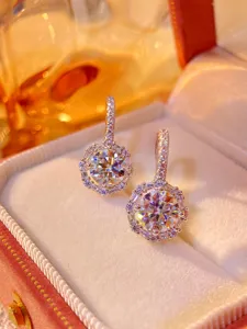Exquisite 1-carat moissanite halo dangle earrings with sparkling round diamonds in velvet box.