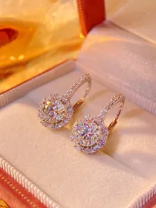 Close-up detail view of sparkling moissanite halo lever-back earrings with brilliant fire & shine.
