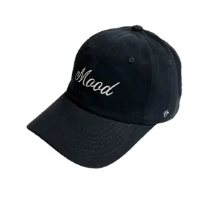 Close-up detail of the black corduroy baseball cap featuring white Mood embroidery.