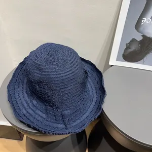 Navy blue wide-brim sun hat detail view, elegant vintage summer bucket hat for vacation chic.