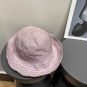 Pink ruffled sun hat detail showing the unique textured fabric and wide brim design.