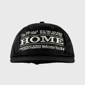 Detailed view of the black street style baseball cap featuring front white embroidery HOME logo.