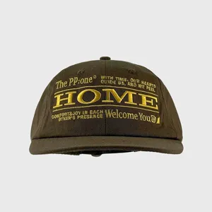 Close-up detail of the dark stylish baseball cap featuring front embroidered gold letters.