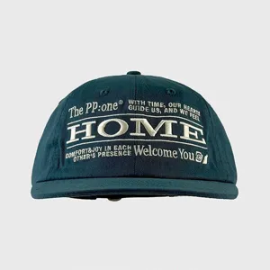 Dark green baseball cap detail shot, showing exquisite white embroidered text and short brim.