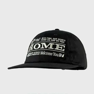 Detailed shot of black streetwear baseball cap with white embroidery lettering and flat brim design.
