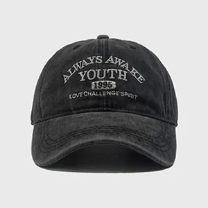 Vintage washed cotton baseball cap close-up, retro embroidered text design, curved brim.