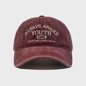 Vintage washed cotton baseball cap with front embroidery letters and curved brim style.