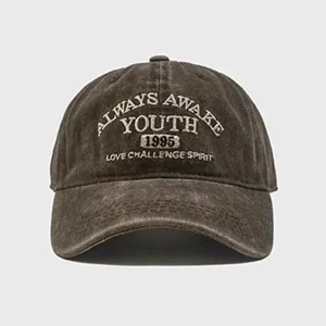 Close-up of vintage washed cotton baseball cap with detailed front embroidery lettering.