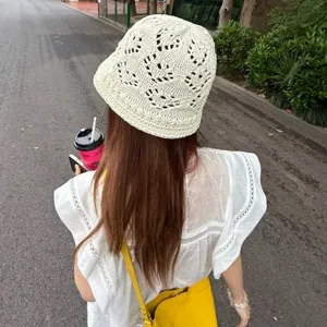 Detailed view of a white crochet mesh bucket hat, breathable summer sun protection sun hat.