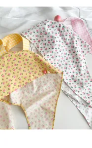 Floral rabbit ear headscarf detail view, cute strap hat fabric close-up shot for women summer.