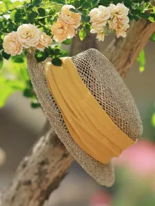 Detailed view of French retro hollow woven straw hat with yellow ribbon, spring summer sun hat.