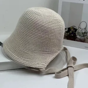 Beige knitted bucket hat with strap, stylish summer sun protection woven fisherman hat for women.
