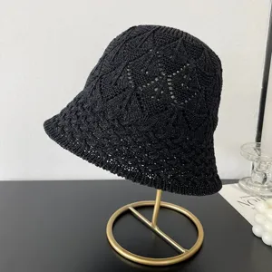 Black knitted bucket hat detail, mesh hollow design, short brim spring summer casual style.