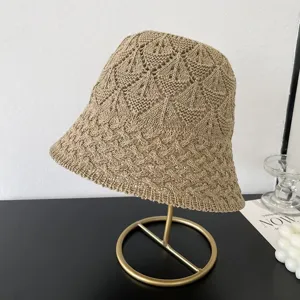 Closeup detail of the knitted mesh bucket hat in khaki, showing intricate hollow texture.