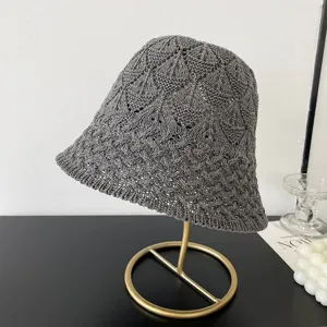 Detailed view of the stylish gray mesh knit bucket hat showing the delicate hollow pattern.