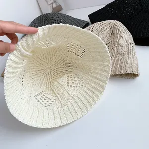 Detailed view of hollow knit bucket hat with breathable diamond cable pattern summer sun.