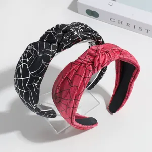 Detailed close-up shot of fashionable Halloween spider web patterned knotted hair bands.