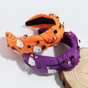 Halloween knotted headband with rhinestones and cute ghost charms, vibrant purple and orange fabric.