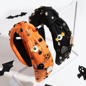 Halloween wide knotted headband with rhinestones, pumpkin, ghost, and eyeball charms for women.