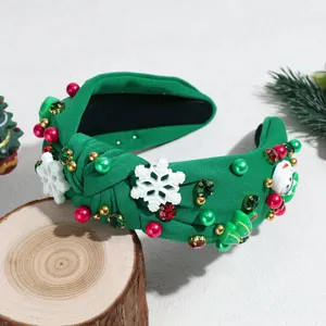 Green Christmas padded headband with white snowflakes, rhinestones, and festive bead decor.