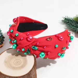 Christmas rhinestone knotted headband detail, red fabric with pearls and holiday gems.