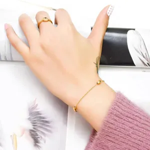 Elegant gold beaded bracelet and matching ring set, minimalist design for daily wear.
