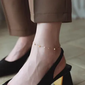 Delicate gold butterfly anklet detail shot, elegant minimalist fashion jewelry for women wear.