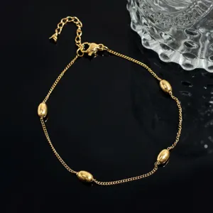 Gold-tone metal bead charm link bracelet with lobster clasp, delicate jewelry accessory