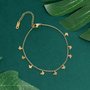 Gold butterfly chain anklet shot, minimalist style metal jewelry accessory for daily wear.