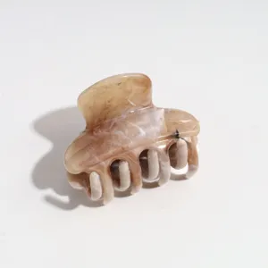 Close-up detail of the brown marbled hair claw clip, compact 4cm size with elegant glossy finish.