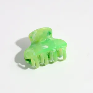 Close up of the green marble small hair claw clip showing glossy finish and teeth detail.