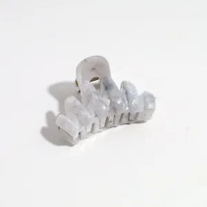 Small marbled hair claw clip detail shot, elegant grey hair accessory for half updo styling.