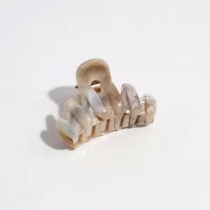 Small 4cm hair claw clip featuring a stylish brown marbled design for half-up hairstyles.