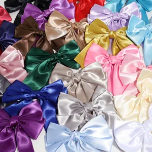 Detailed close-up of multi-color satin bow hair clips showcasing rich fabric texture.