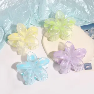 Detailed shot of translucent candy colored flower hair claws, aesthetic design and bright tones.
