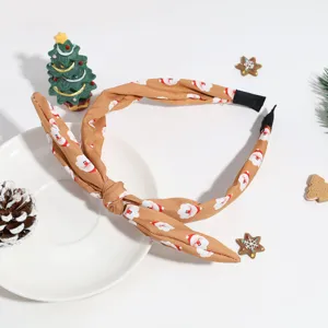 Bandeau en tissu imprimé Père Noël de Noël avec design de nœud torsadé, accessoire festif.