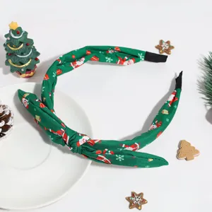 Bandeau de Noël vert et élégant avec imprimé de Père Noël, détail de nœud en gros plan.