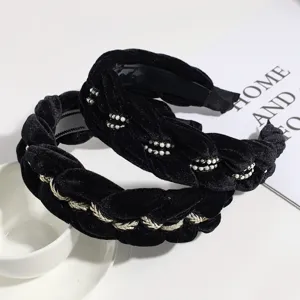 Detailed close-up of black velvet braided hair hoop featuring delicate pearls and golden rope.