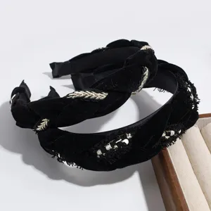 Black velvet headband closeup, stylish braided and frayed design, elegant autumn winter hair accessory