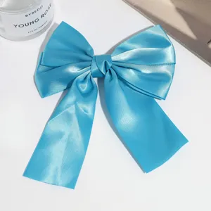 Blue satin ribbon bow hair clip, elegant duckbill hair accessory for stylish daily wear.