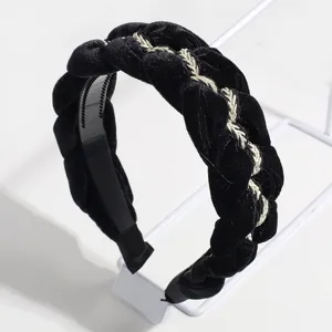 Velvet braided headband detail showcasing the gold thread weave and soft black texture.