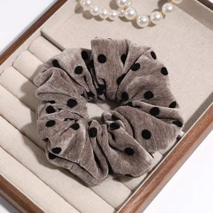 Brown velvet polka dot scrunchie detail shot, elegant plush hair tie accessory for women.