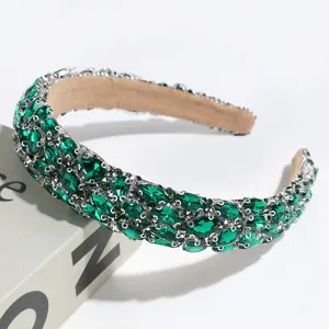 Detailed view of a luxury Baroque green rhinestone headband, elegant banquet hair accessory.