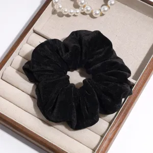 Black velvet hair scrunchie close-up view, elegant daily hair accessory for ponytails.
