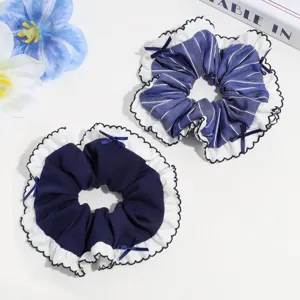 Detail shot of cute blue and white lace ruffle hair scrunchies with sweet bows accessory.