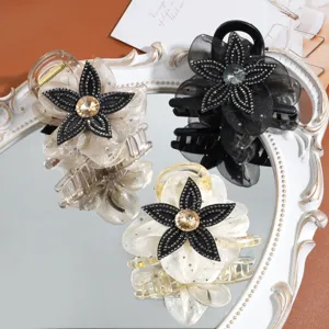 Detailed view of elegant mesh flower hair claw clip with sparkly rhinestones for stylish look.