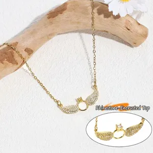 Detail view of gold-plated rhinestone angel wings clavicle chain necklace jewelry piece.