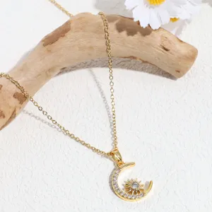 Gold rhinestone sun moon pendant necklace detail view showcasing sparkling crystal jewelry design
