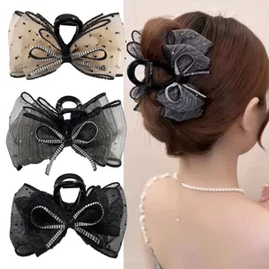 Elegant mesh bow hair claw clip featuring sparkling rhinestones, perfect for chic hairstyles.